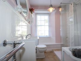 A bathroom with sink, toilet, shower, and mirror at Rosedale in St. Ives