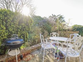 A garden with a barbecue and outdoor seating at Rosedale in St. Ives