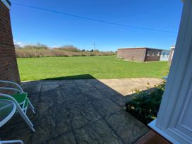 A garden with a patio and grass at 300 California Sands in California, Norfolk