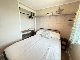 A bedroom with bed and bedside table at 300 California Sands, California, Norfolk