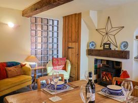A dining room with a table set for a meal at Rope Cottage in Bridport