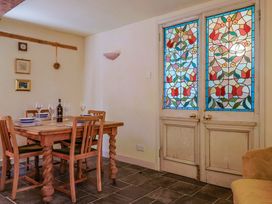 A dining room with a table set for dinner at Rope Cottage in Bridport