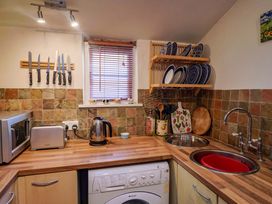 A kitchen with appliances and utensils at Rope Cottage in Bridport