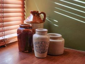 A collection of jars on a wooden surface at Rope Cottage in Bridport