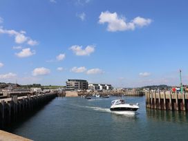 A view of a marina with boats and buildings at Rope Cottage in Bridport