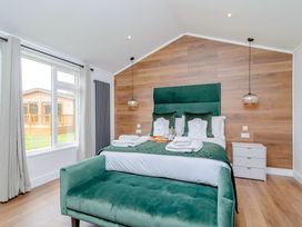 A bedroom with a bed and a view of the outside at The Castor in Kings Cliffe