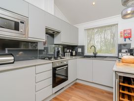A kitchen with appliances including a microwave and oven at The Castor in Kings Cliffe