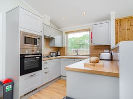 A kitchen with appliances and a window at The Kingscliffe (Pet) Kings Cliffe