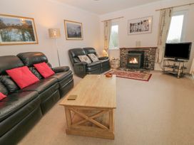 A living room with a fireplace and sofa at Orchard End in Launceston