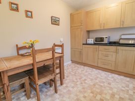 A kitchen with a dining table and chairs at Orchard End in Launceston