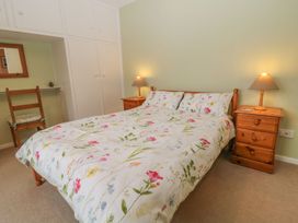 A bedroom with a bed and nightstands at Orchard End in Launceston