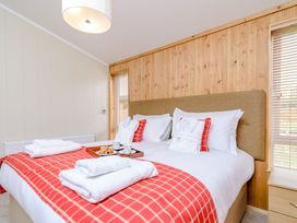 A bedroom with a bed and breakfast items at The Sutton (Pet) in Kings Cliffe