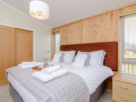 A bedroom with a bed and a bedside table at The Chesterton in Kings Cliffe