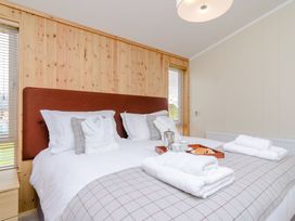 A bedroom with a bed, towels, coffee tray at The Chesterton in Kings Cliffe