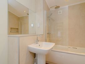 A bathroom featuring a sink, bathtub, and shower at The Chesterton (Pet) Kings Cliffe