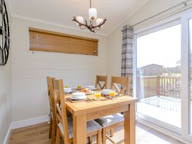 A dining room with a table and chairs at The Chesterton (Pet) in Kings Cliffe