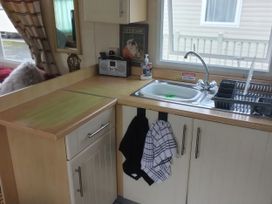 A kitchen with a sink and countertop at No. 30 First Avenue in Rhyl