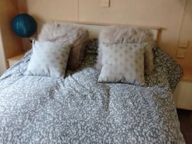 A bedroom with a bed and pillows at No. 30 First Avenue, Rhyl