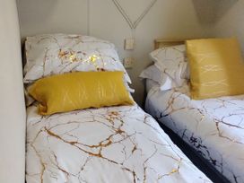 A bedroom with two beds and pillows at No. 30 First Avenue Rhyl