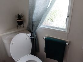 A bathroom with a toilet and window at No. 30 First Avenue in Rhyl