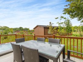A dining table with chairs on a deck at The Nassington (Pet) Kings Cliffe