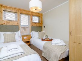 A bedroom with two beds and a tray with tea at The Nassington (Pet) Kings Cliffe