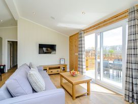 A living room with a sofa and television at The Yarwell in Kings Cliffe