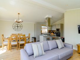 A living room with a sofa and dining area at The Yarwell in Kings Cliffe
