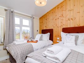 A bedroom with two beds and a window at The Yarwell (Pet) in Kings Cliffe