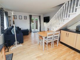 A living room with a sofa and dining table at Beadlin cottage Beadnell