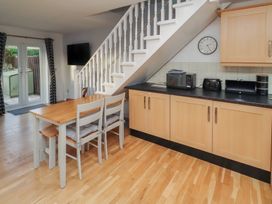 A kitchen with a table and chairs at Beadlin cottage in Beadnell