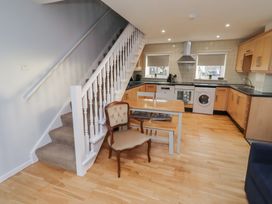 A kitchen with a table and chairs at Beadlin cottage Beadnell