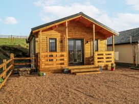 A log cabin with steps and gravel area at Glenview Log Cabin in Ballycastle