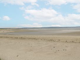 A beach with sand and water at Glenview Log Cabin in Ballycastle