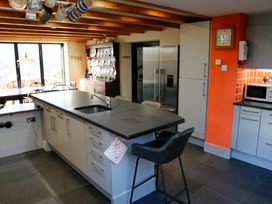 A kitchen with an island and refrigerator at Ty Uchaf in Colwyn Bay