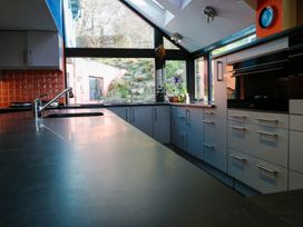 A kitchen with a sink and stove at Ty Uchaf in Colwyn Bay