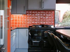 A kitchen with a stove and cabinet at Ty Uchaf in Colwyn Bay