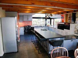 A kitchen with appliances and counter space at Ty Uchaf in Colwyn Bay