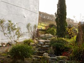 A garden with a stream and plants at Ty Uchaf in Colwyn Bay
