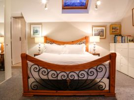 A bedroom with a bed and nightstands at Ty Uchaf in Eglwysbach