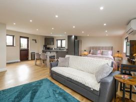 A studio with a sofa and bed at Aloe Lodge in Banham