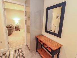 A hallway with a console table and a mirror at 20 Lorton Street in Cockermouth