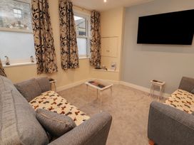 A living room with a sofa and television at 20 Lorton Street Cockermouth