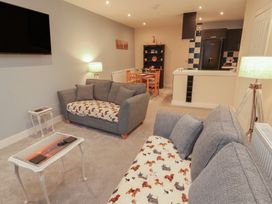 A living room with a sofa and television at 20 Lorton Street Cockermouth