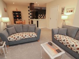 A living room with sofas and a dining area at 20 Lorton Street in Cockermouth