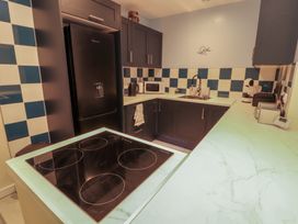 A kitchen with appliances and a cooking hob at 20 Lorton Street Cockermouth