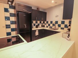 A kitchen with appliances and cabinets at 20 Lorton Street in Cockermouth