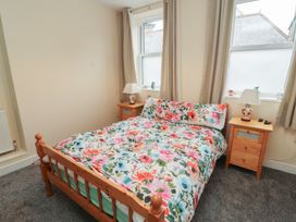 A bedroom with a bed and bedside tables at 20 Lorton Street in Cockermouth
