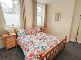 A bedroom with a bed and bedside tables at 20 Lorton Street Cockermouth