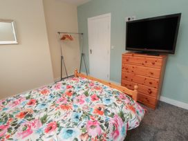 A bedroom with a bed and television at 20 Lorton Street Cockermouth
